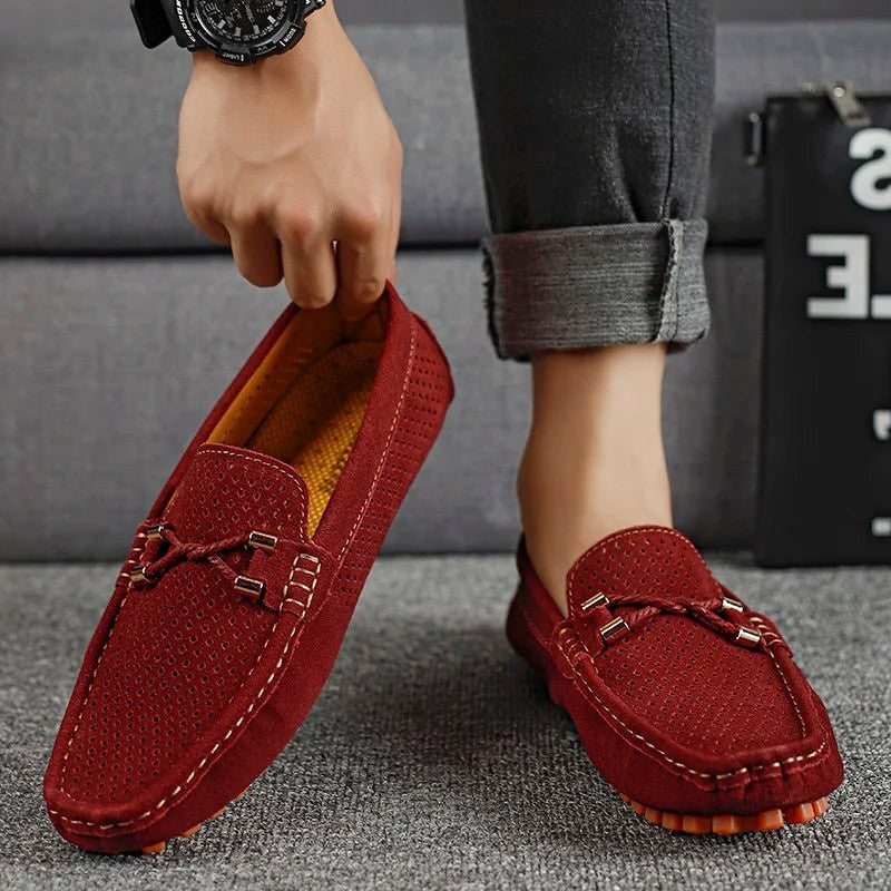 Wine red suede perforated loafers styled with rolled-up denim trousers