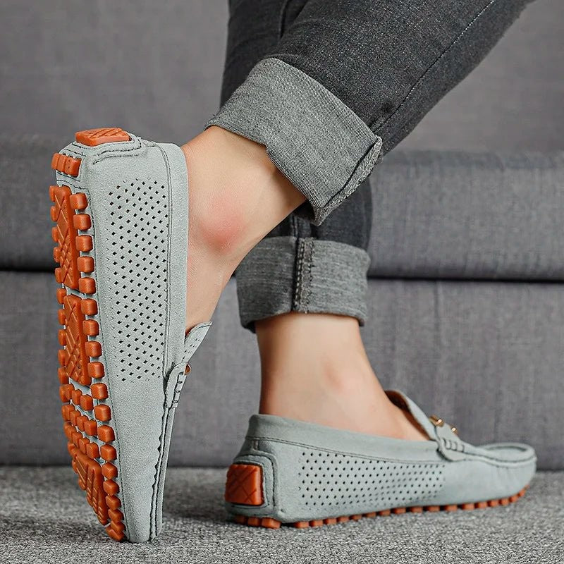 Grey suede perforated loafers showing textured orange pebble sole