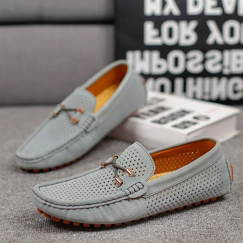 Grey suede perforated loafers paired with an orange rubber sole