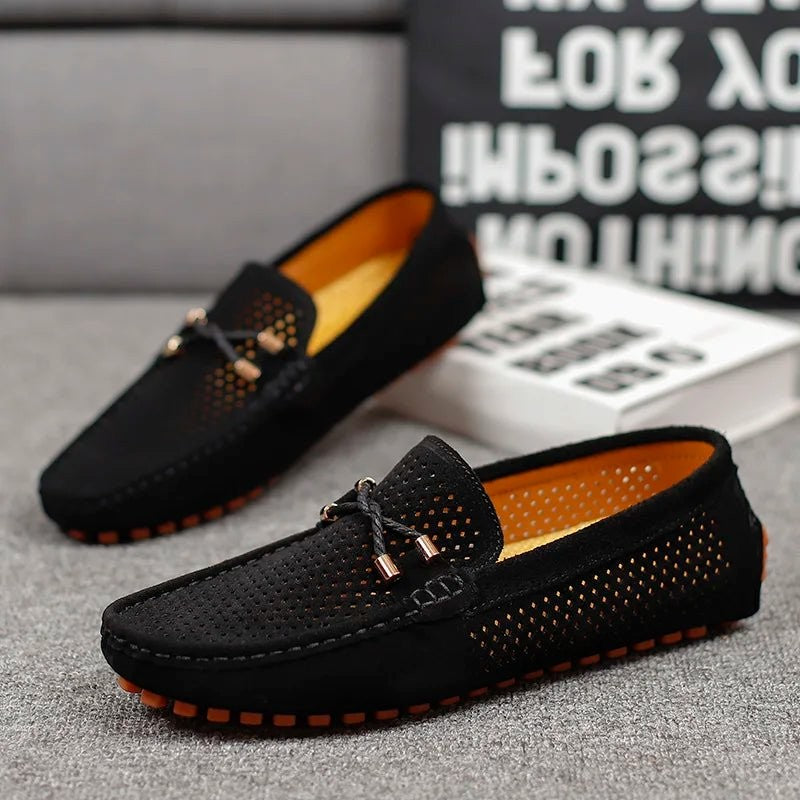Black suede perforated loafers with orange sole and bright yellow lining