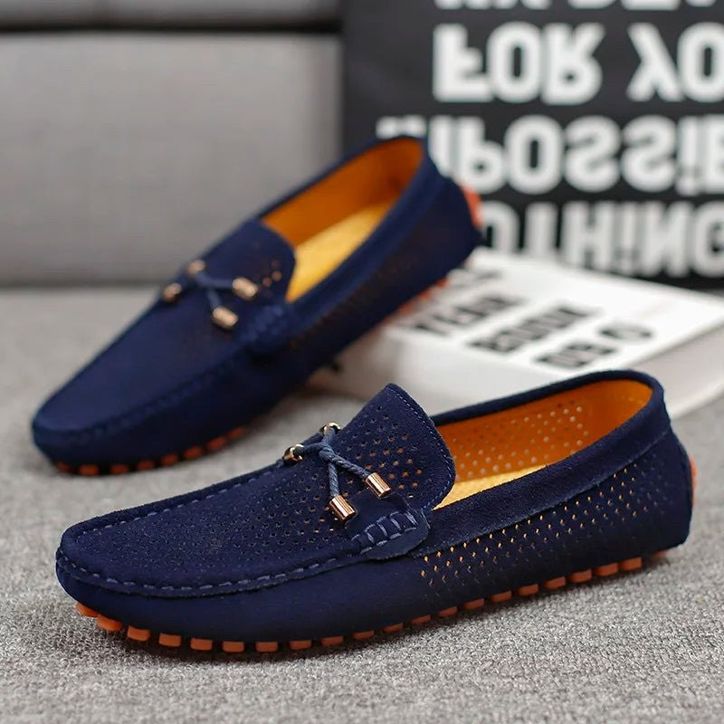 Navy blue suede perforated loafers with tied bow trim and orange sole