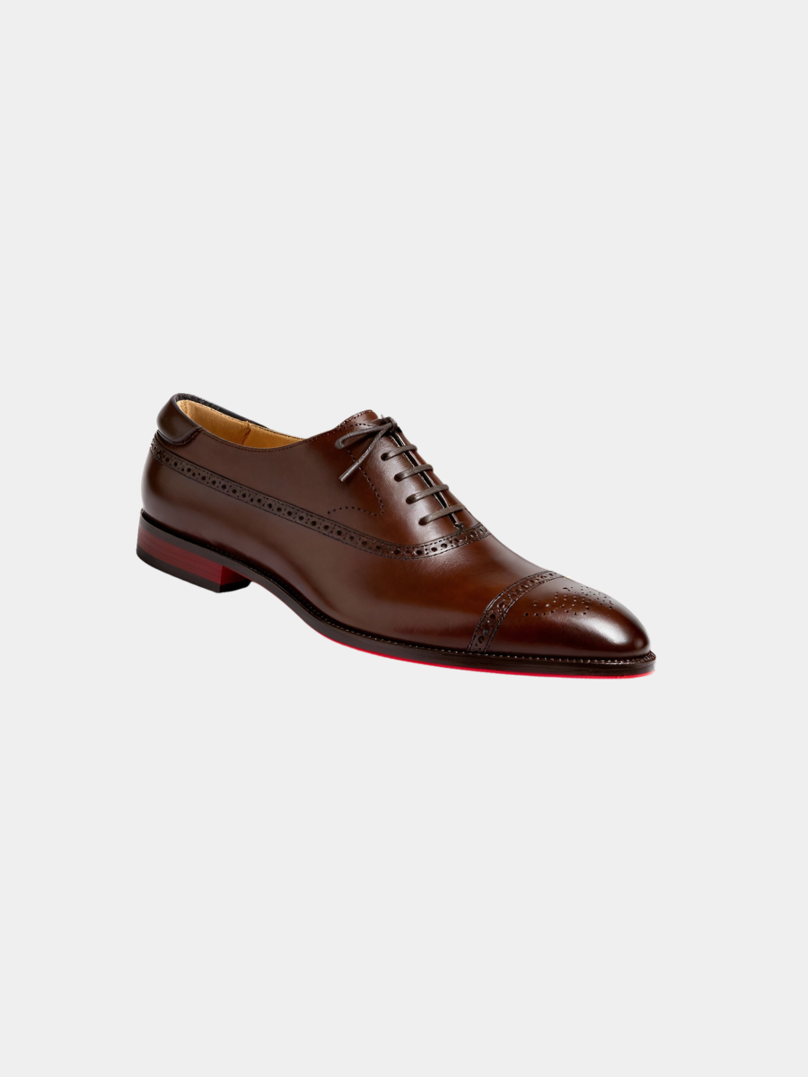 Brown leather Oxford shoe with brogue detailing and red sole