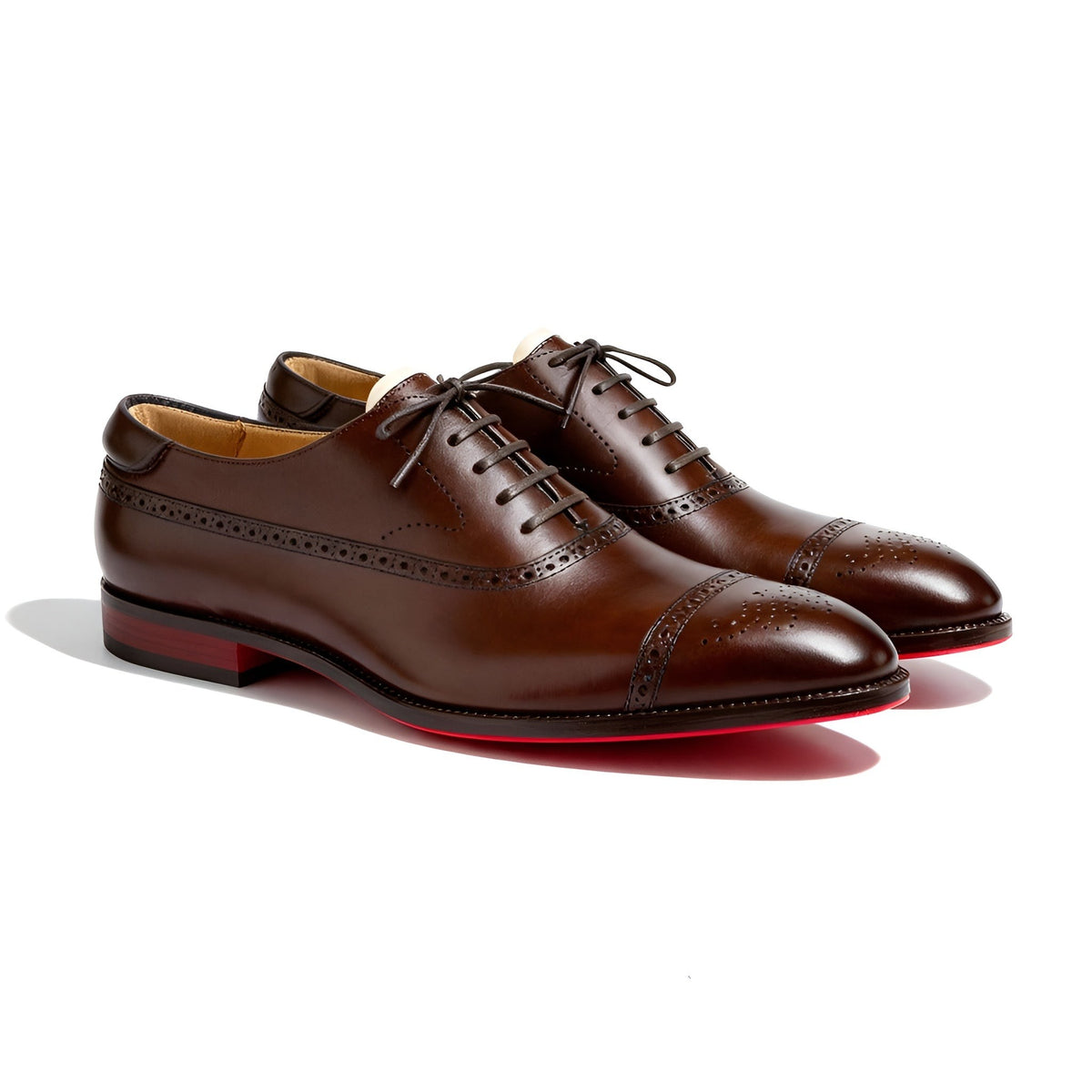 Pair of brown leather brogue Oxford shoes with red soles