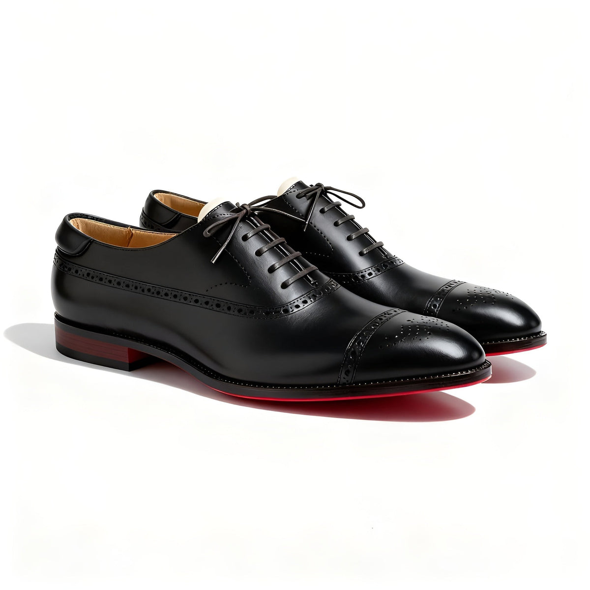 Black leather Oxford shoes featuring perforated cap toe and red sole