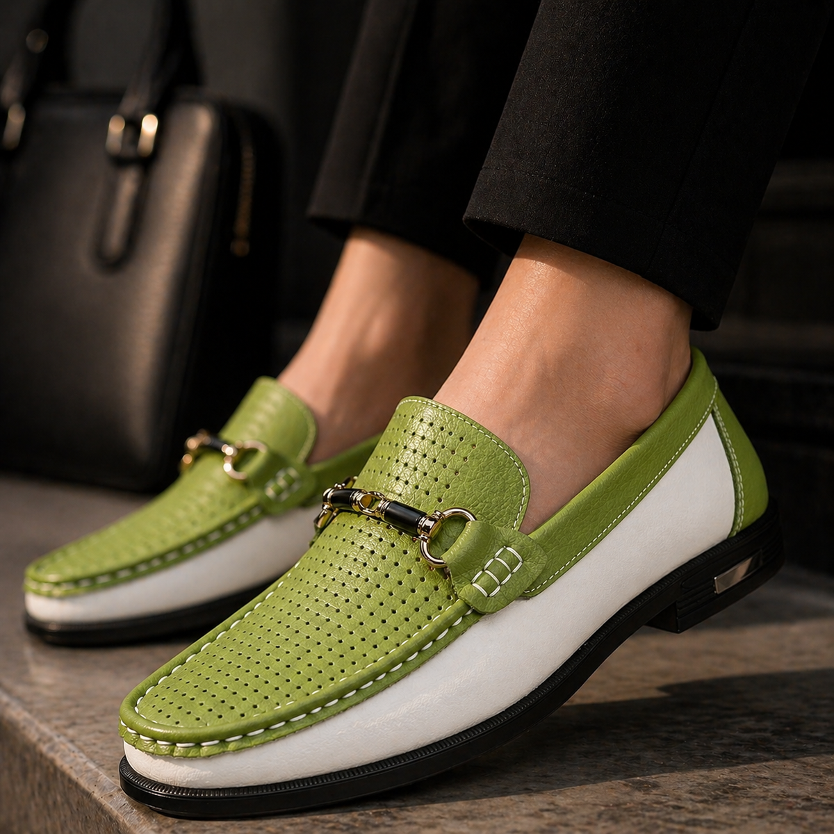 Green and white perforated loafers worn with tailored black trousers