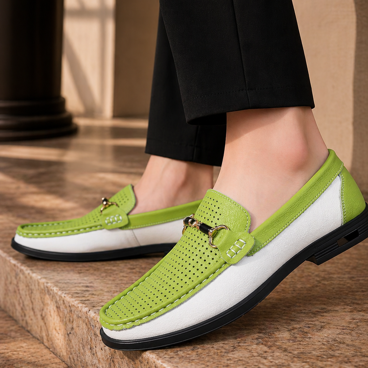 Pair of green and white leather loafers styled with black trousers