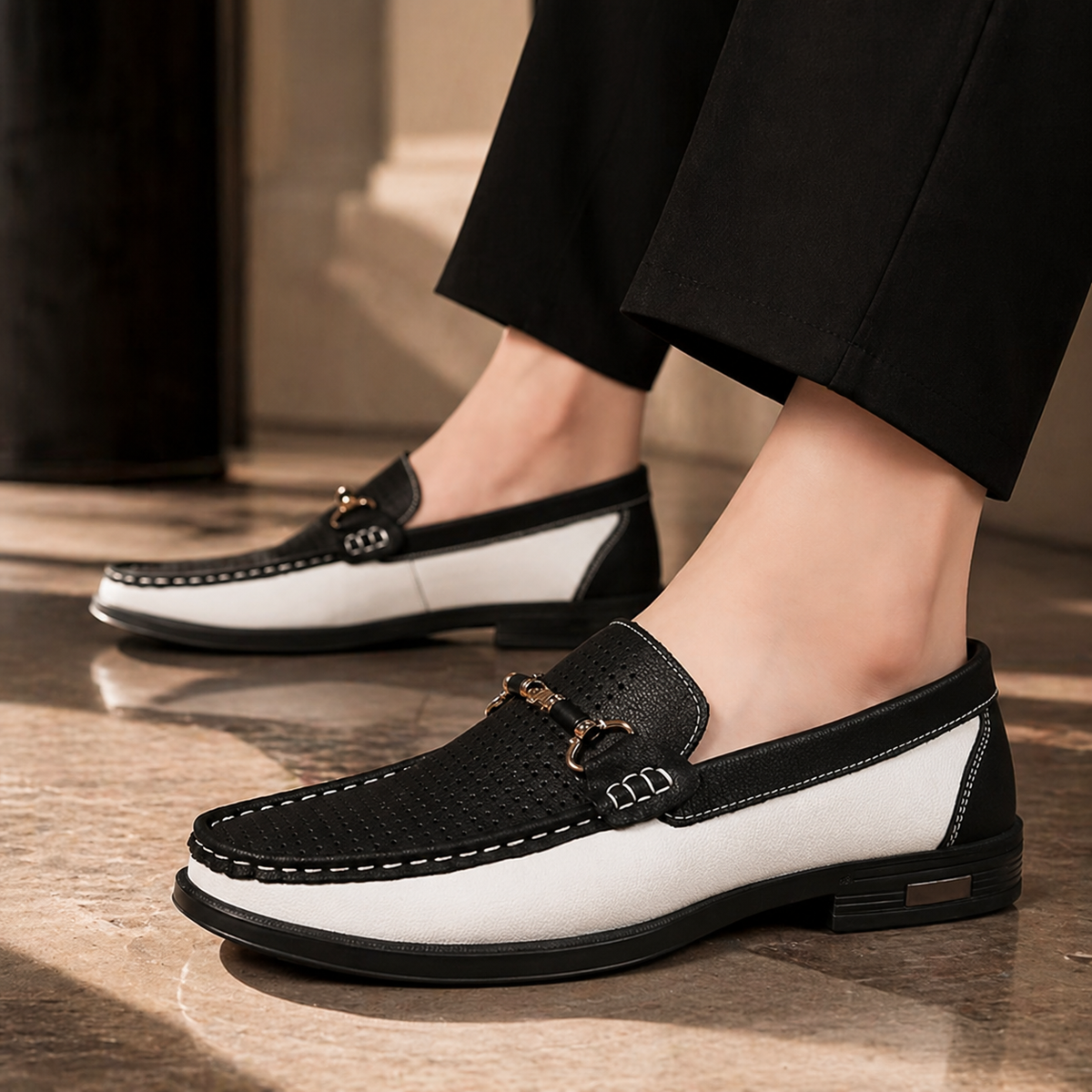 Black and white slip-on loafers styled with tailored black trousers