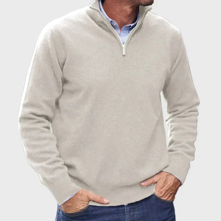 Oatmeal quarter-zip knitted jumper worn over a light blue collared shirt