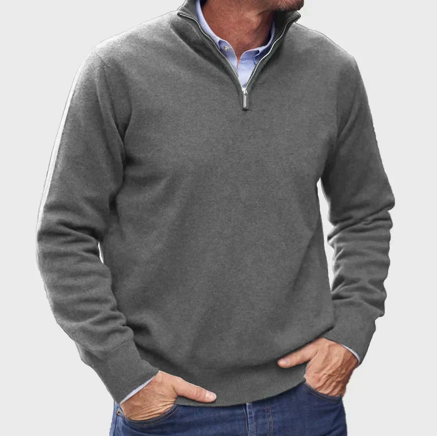 Charcoal grey quarter-zip pullover paired with denim jeans and a shirt