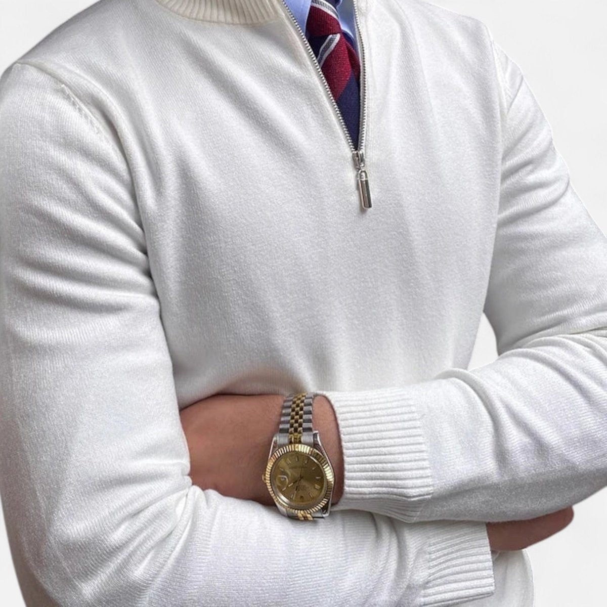 White quarter-zip jumper with ribbed cuffs worn over collared shirt