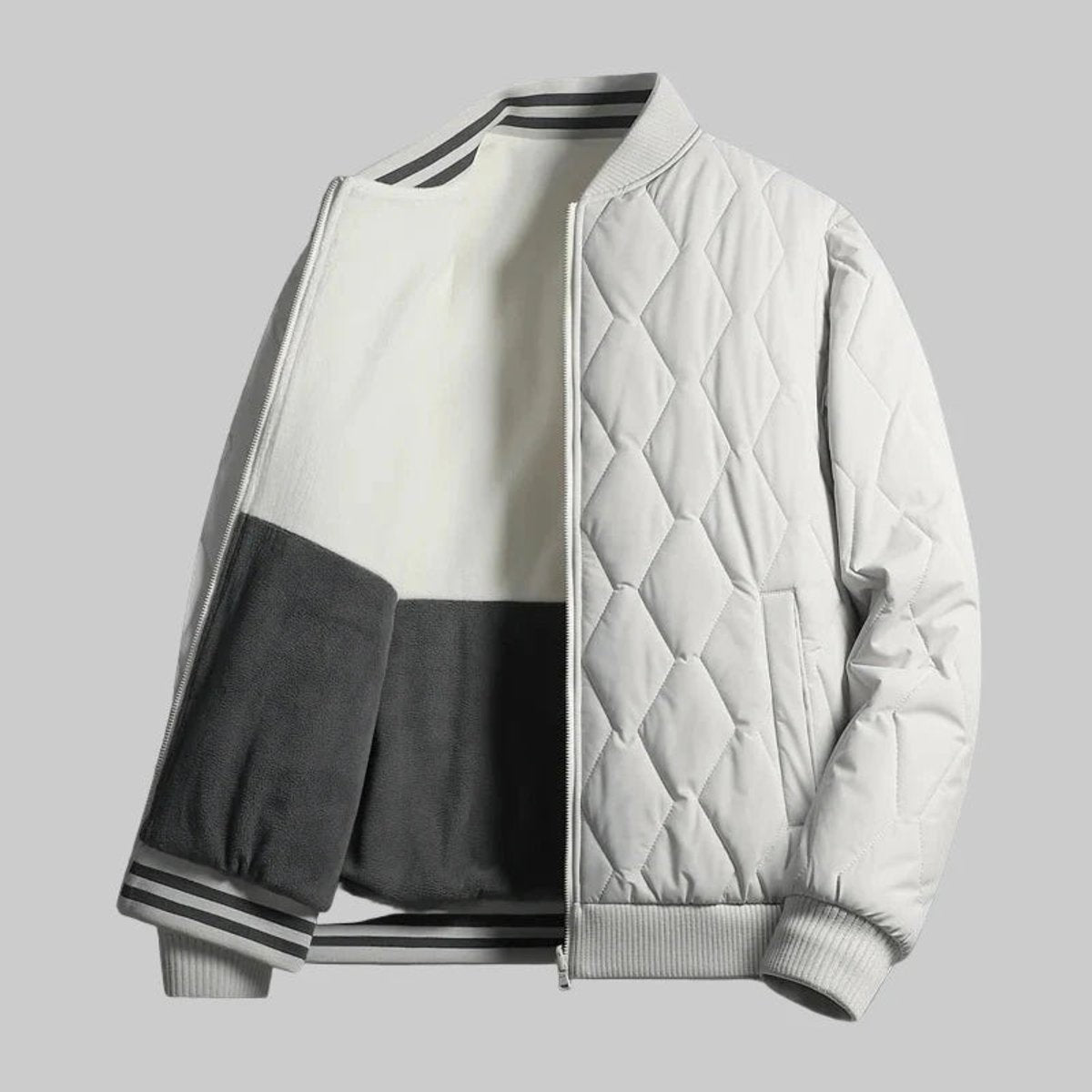 Grey quilted bomber jacket with fleece-lined sleeves and striped ribbed trim