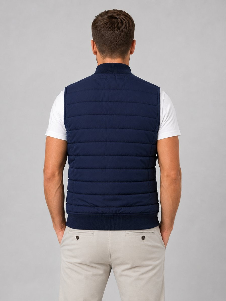 Rear view of navy quilted bodywarmer showing ribbed hem and collar