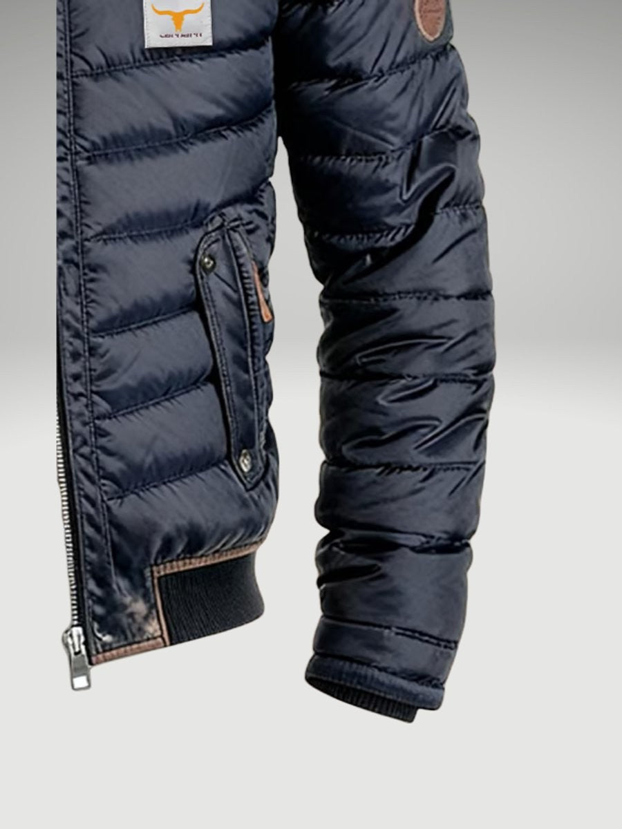 Close-up of quilted sleeve and side pocket on navy bomber jacket