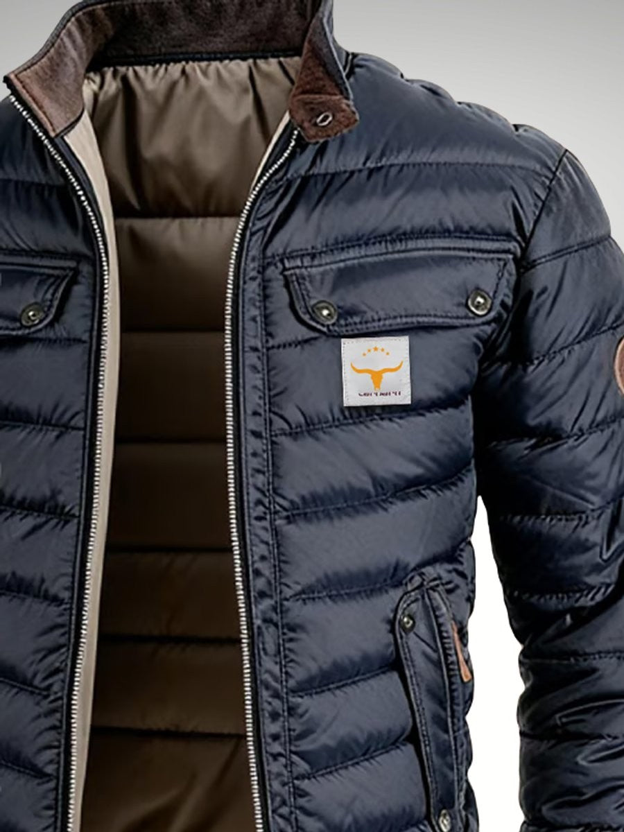 Detail of chest patch pocket and branded logo on navy puffer jacket