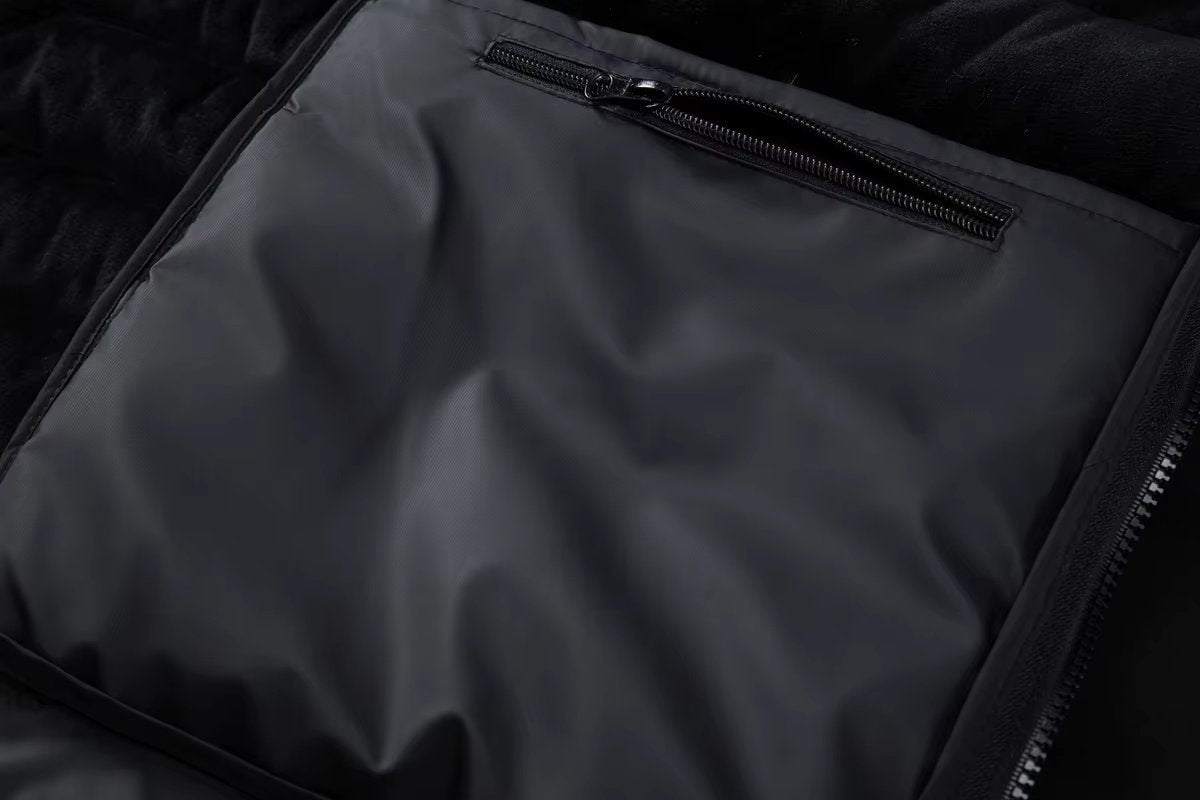 Zipped inner pocket detail inside black puffer bomber jacket lining