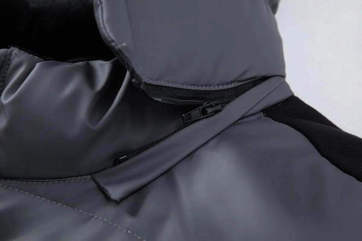 Close-up of zip and hood seam on grey hybrid puffer jacket