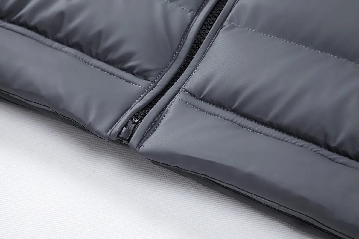 Close-up of front zip fastening on grey quilted puffer bomber jacket