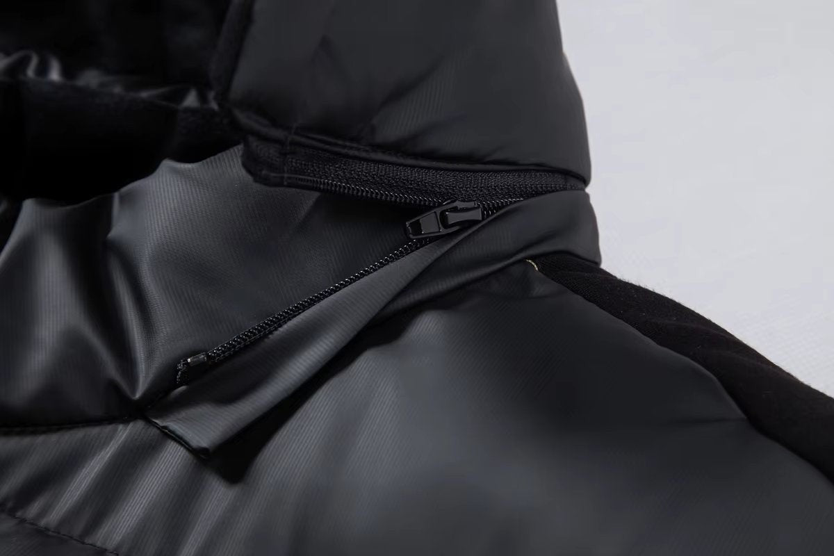 Detail of zip fastening and quilted panel on black waterproof puffer jacket