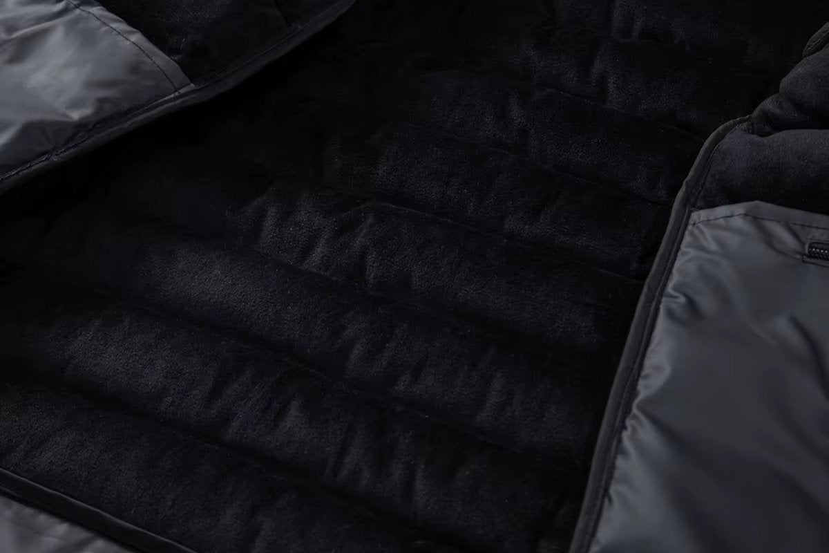 Interior fleece lining visible inside open black puffer jacket