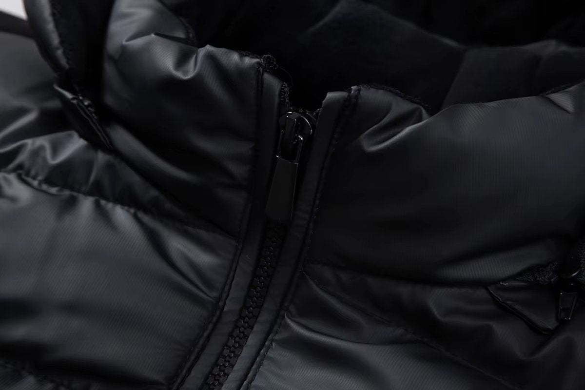 Close-up of front zip and hood quilting on black puffer bomber jacket