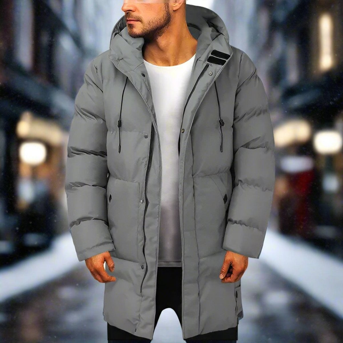 Grey quilted hooded puffer coat worn mid-length on man in snowy street
