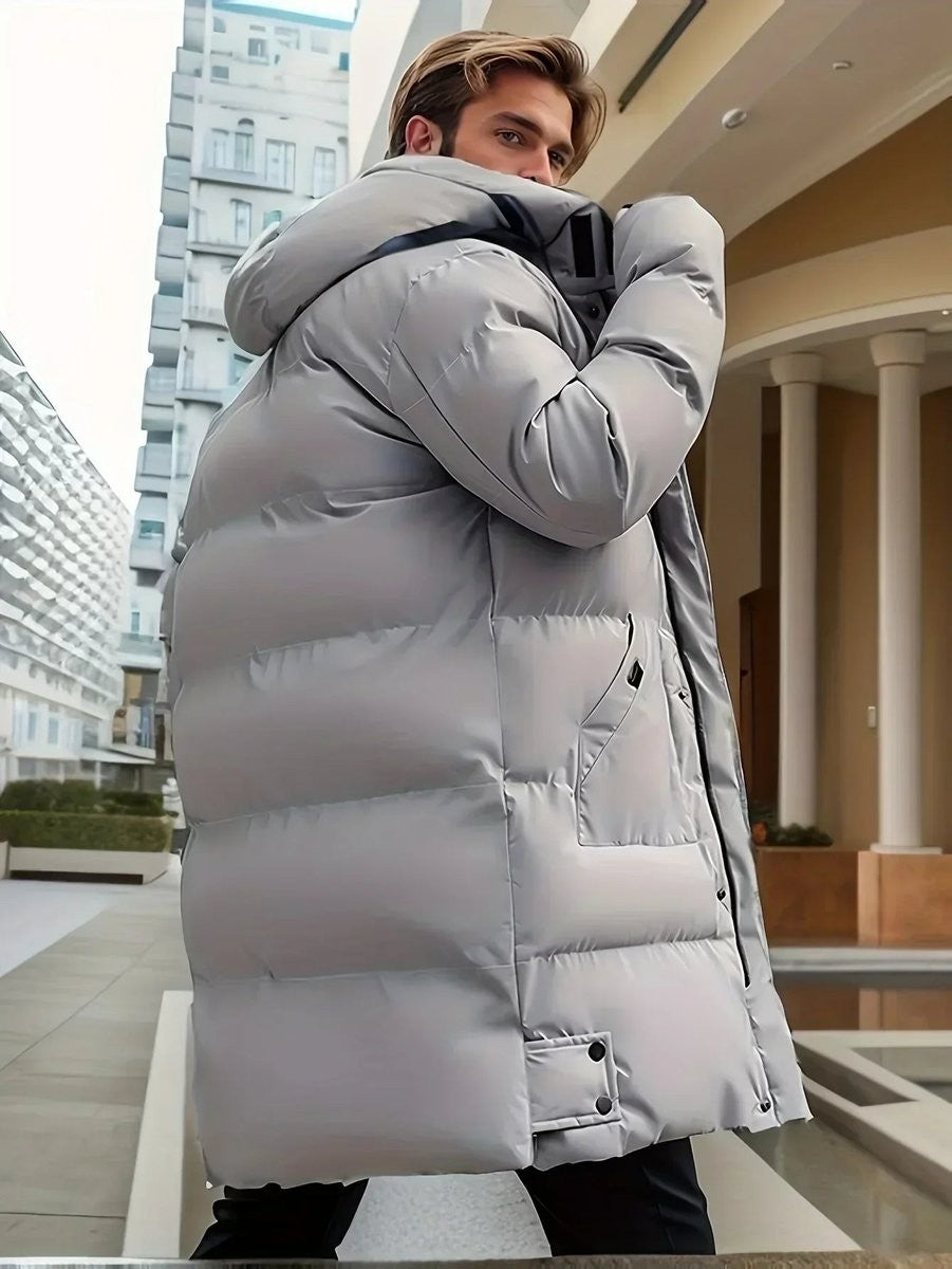 Rear view of grey mid-length puffer coat showing hood and side pocket