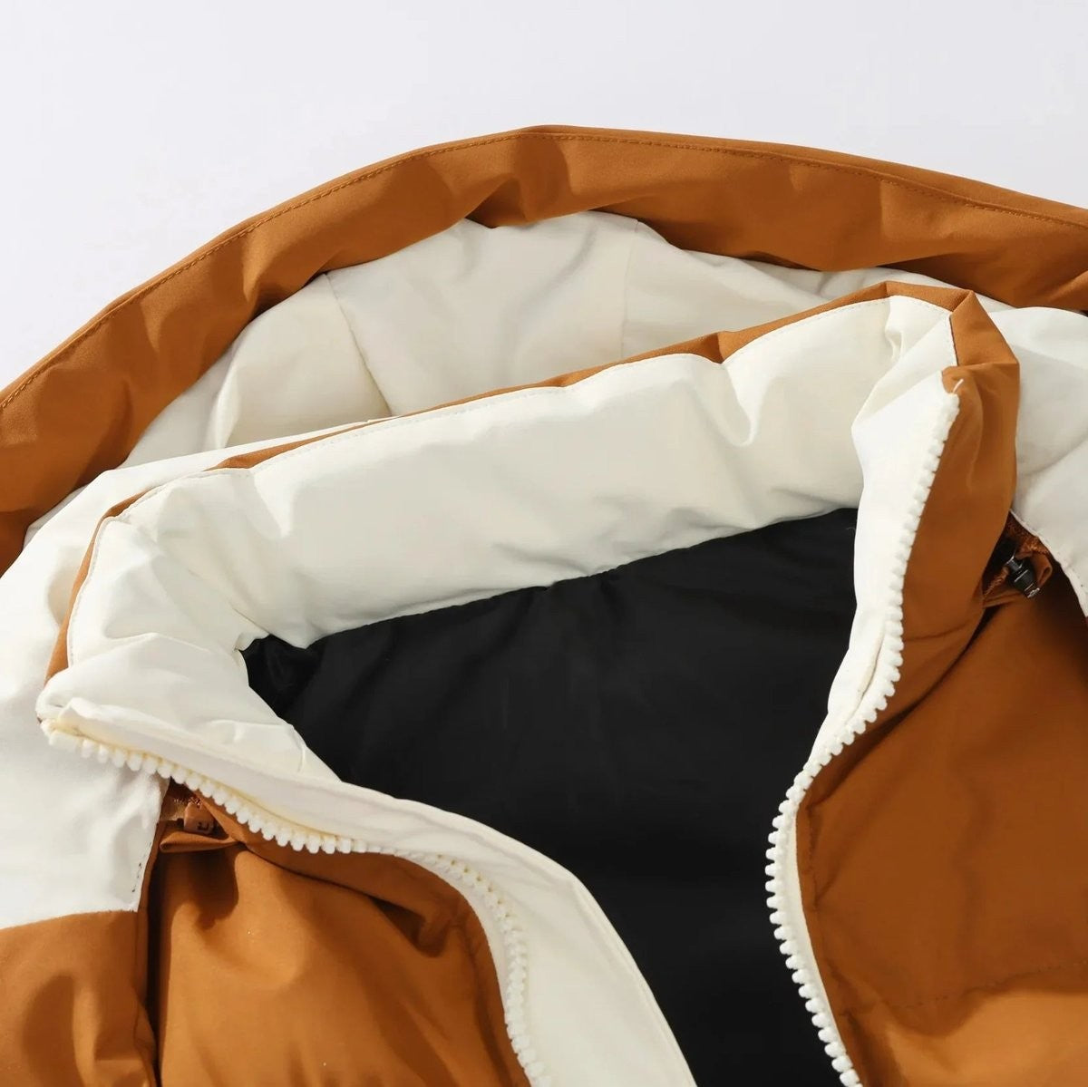 Close-up of tan gilet hood showing cream lining and black interior