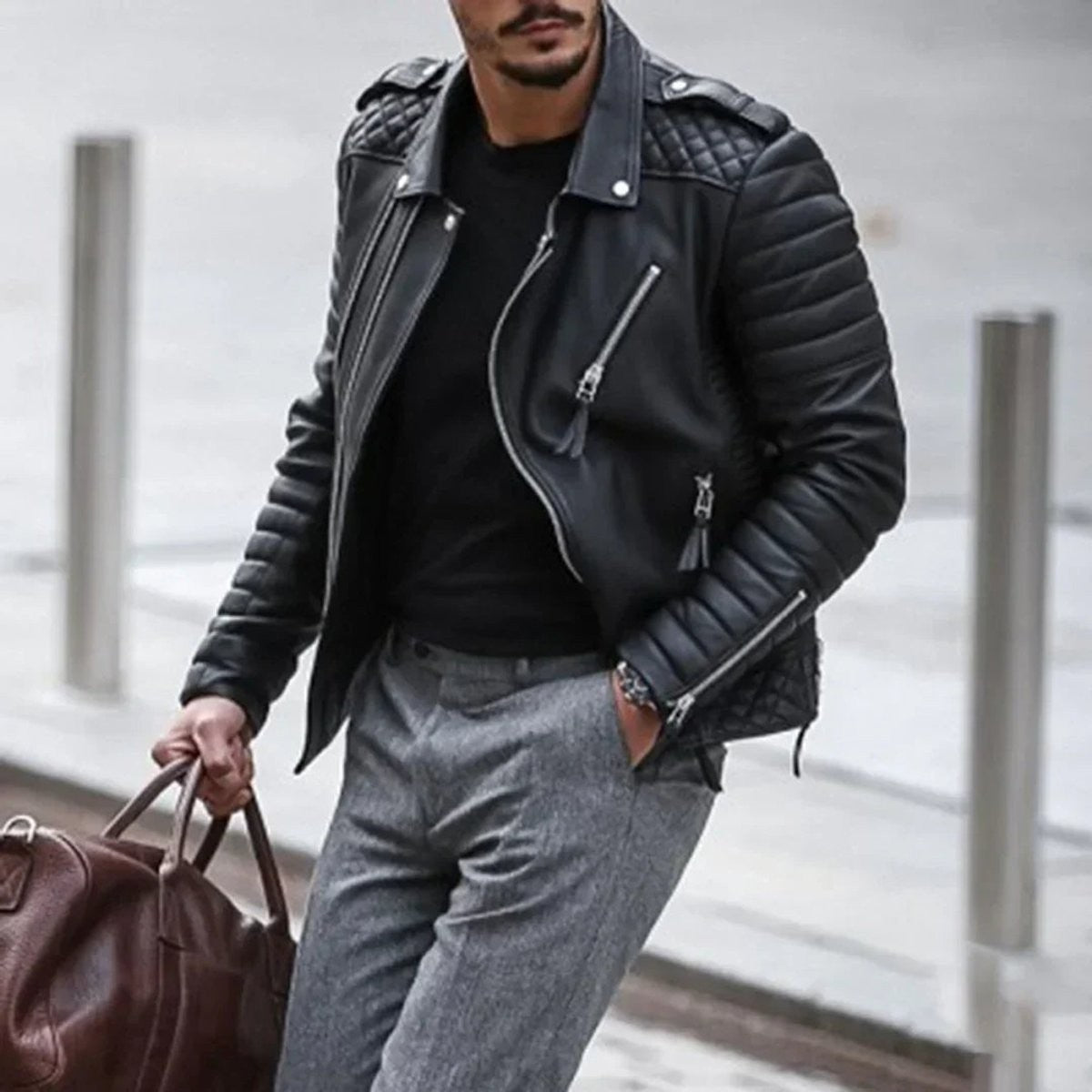 Black faux leather biker jacket with zip detailing worn over a black t-shirt