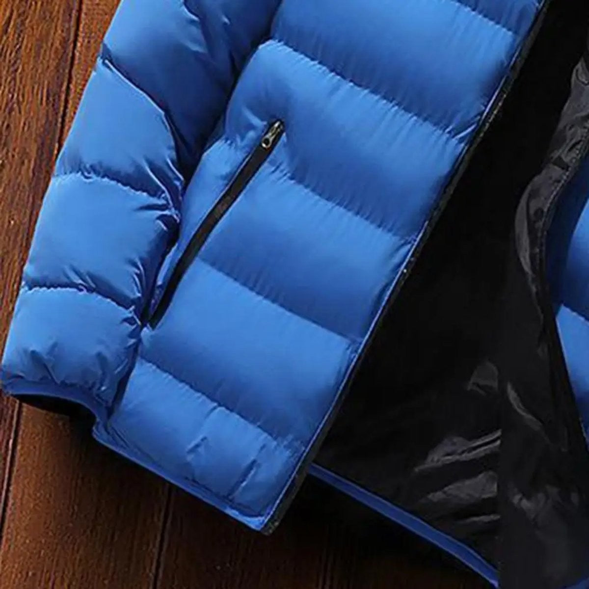 Close-up of blue quilted puffer jacket zip pocket detail