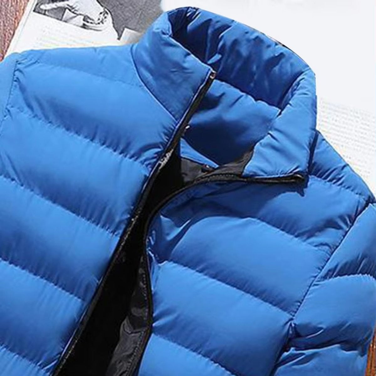 Close-up of blue puffer jacket collar and zip fastening