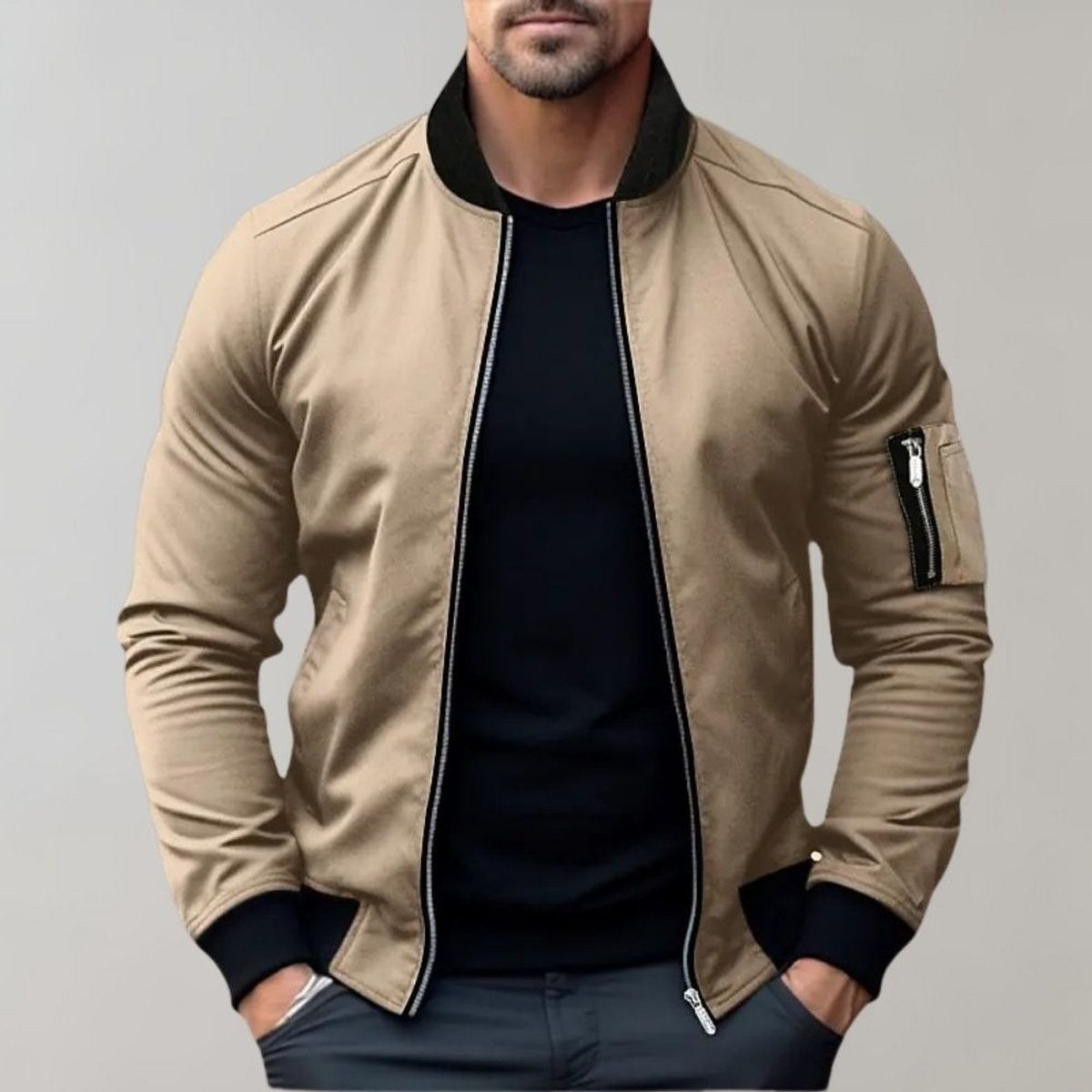 Beige bomber jacket with contrasting black collar worn over black t-shirt
