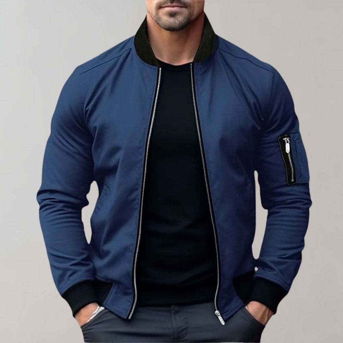 Navy blue bomber jacket with black ribbed cuffs worn by male model