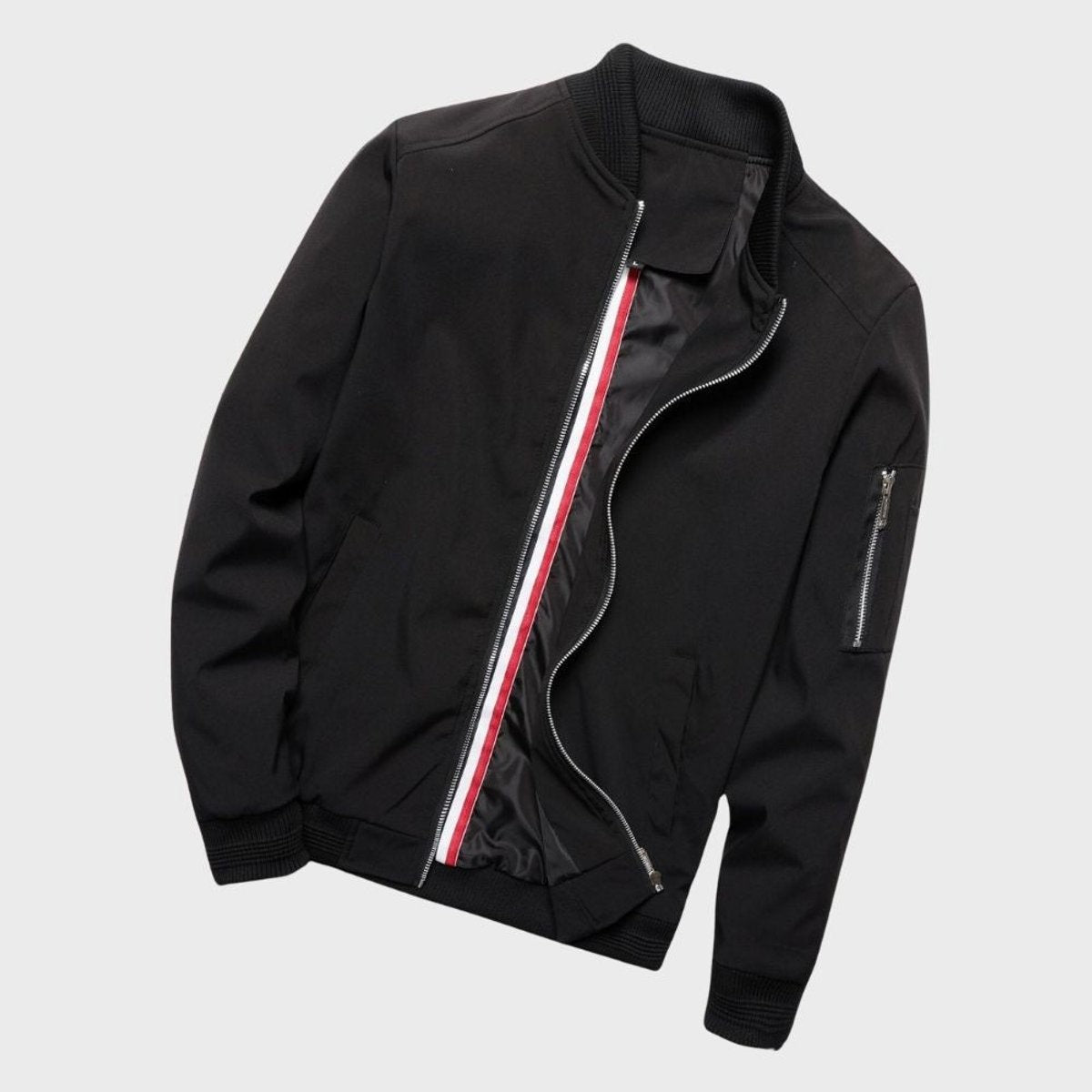 Black zip-up bomber jacket laid flat showing red and white striped trim