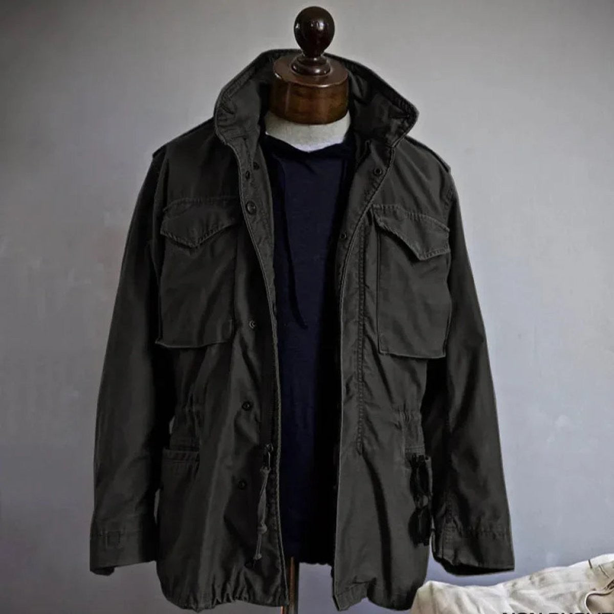 Dark grey vintage-inspired field jacket with hooded collar and cargo pockets