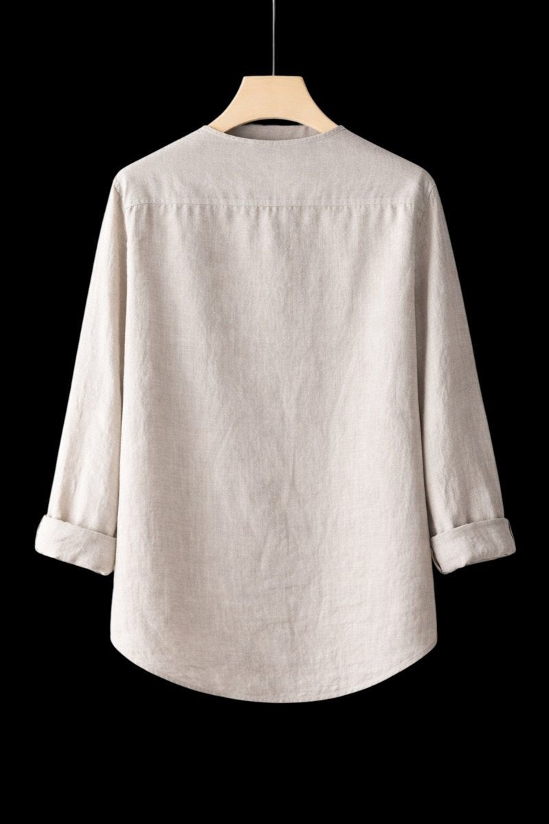 Rear view of beige linen Henley shirt with rolled cuffs on hanger