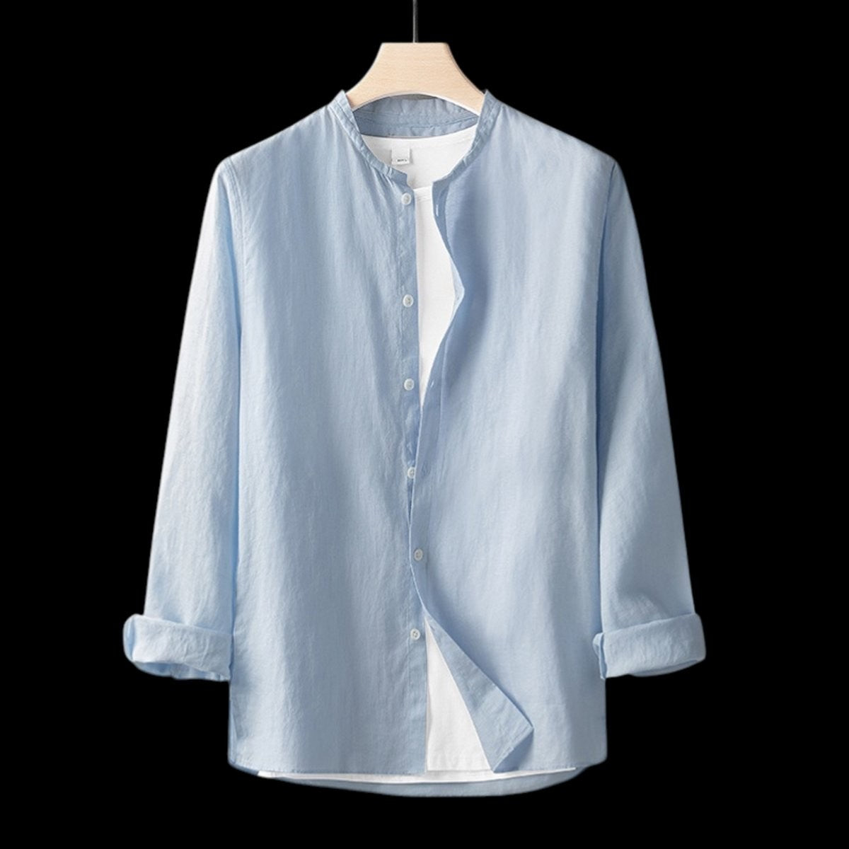 Pale blue linen Henley shirt featuring relaxed fit and rolled sleeves
