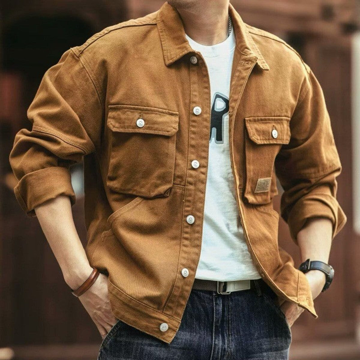 Tan brown cotton canvas utility jacket worn with dark denim jeans