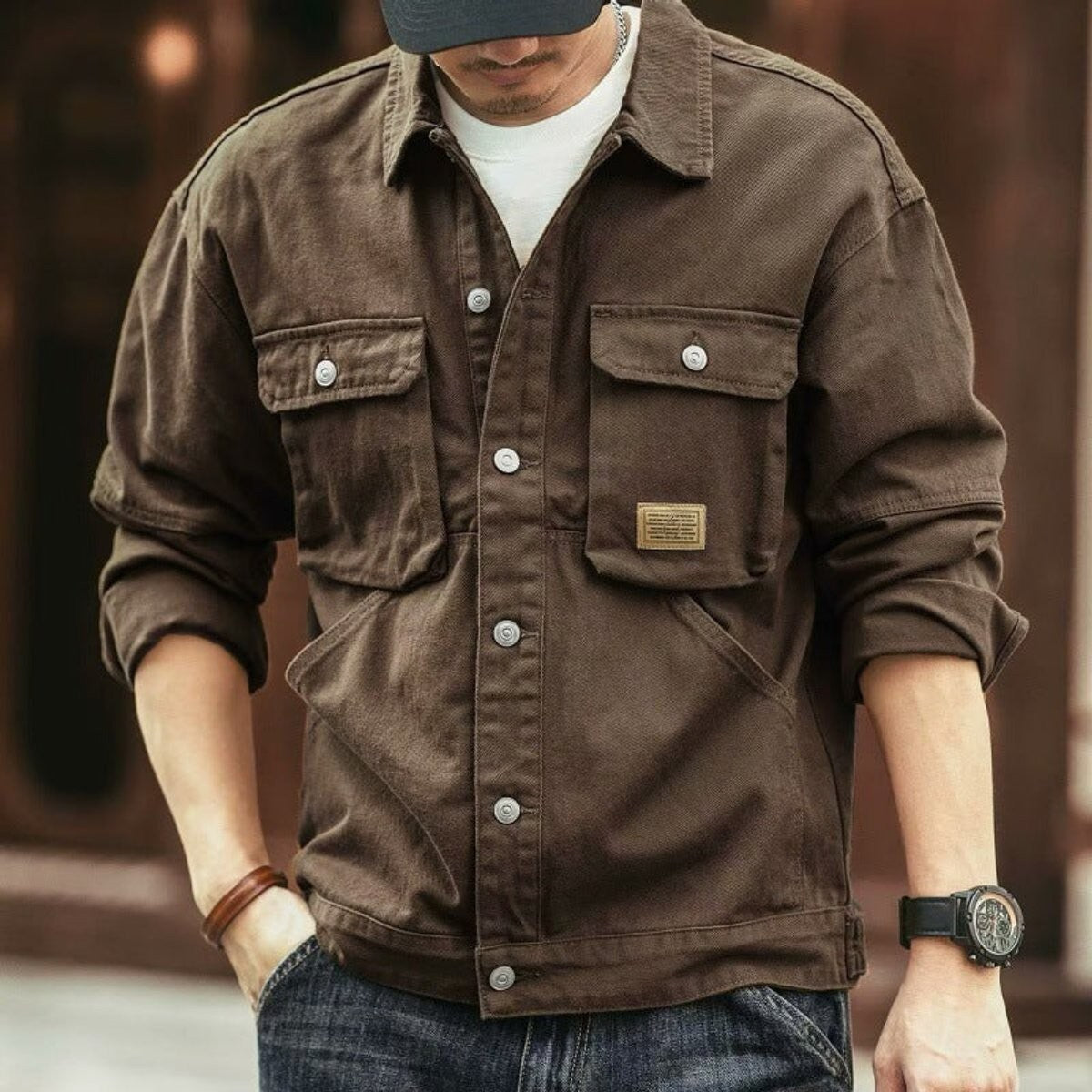 Dark brown cotton canvas utility jacket styled with a baseball cap