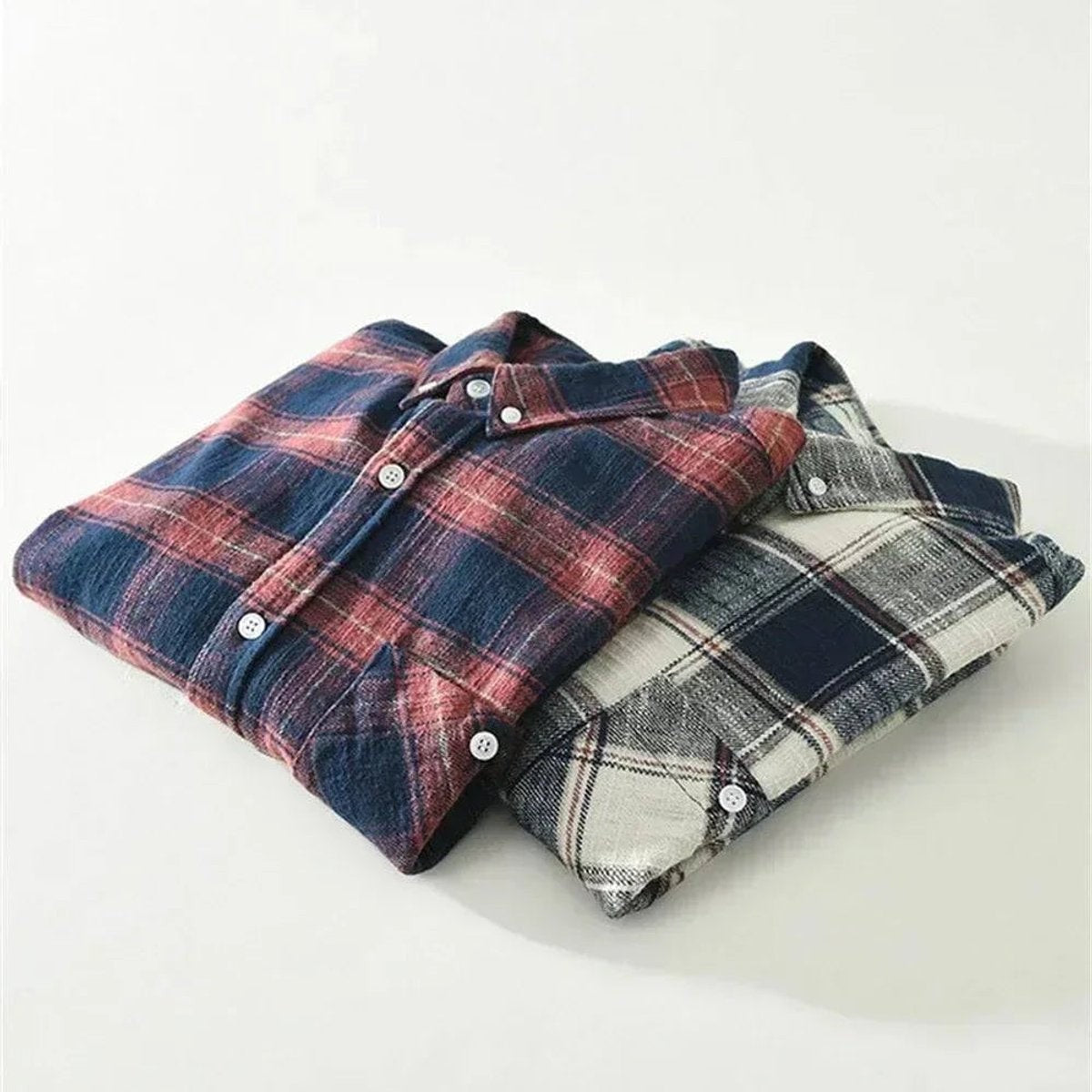 Folded navy check flannel shirts showing relaxed-fit collar and cuff detail