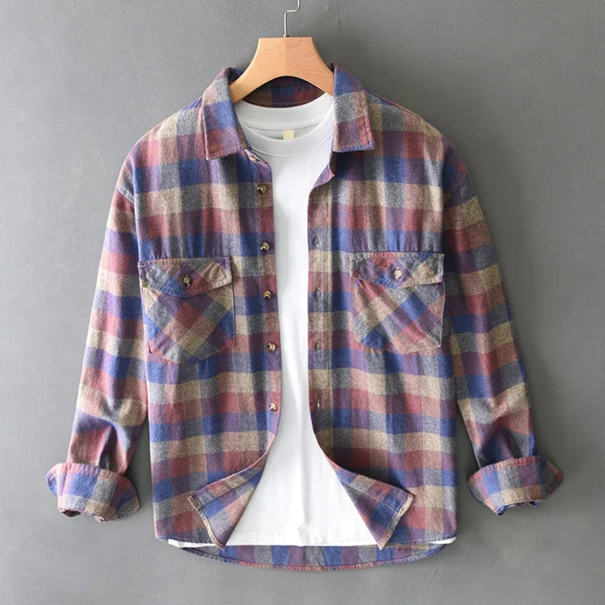 Blue and red plaid flannel shirt featuring button cuffs and dual front pockets