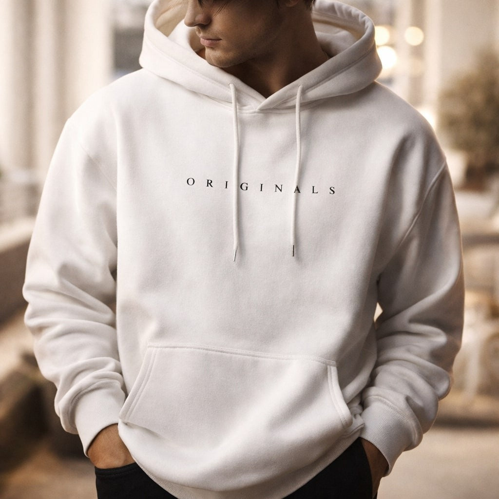 Man wearing white relaxed hoodie with hands in front pocket