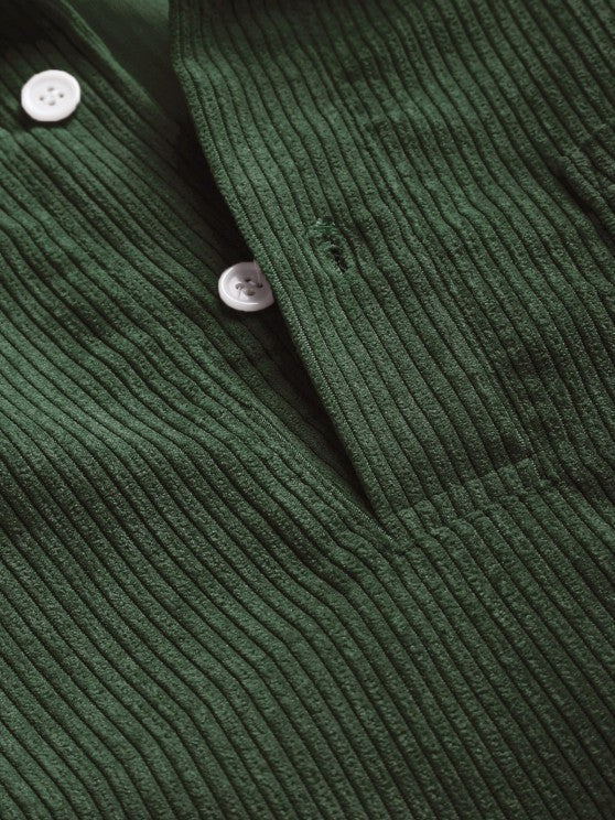 Close-up of forest green corduroy collar with white buttons