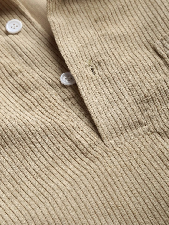 Close-up of beige corduroy collar and stitched button detail