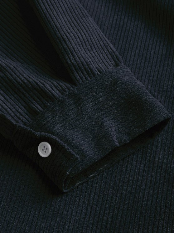 Close-up of navy corduroy cuff with button fastening