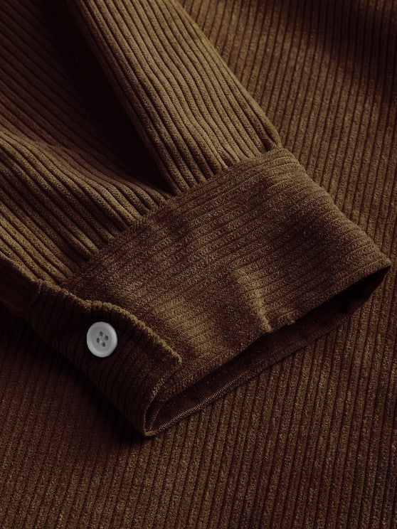 Close-up of olive brown corduroy cuff with white button