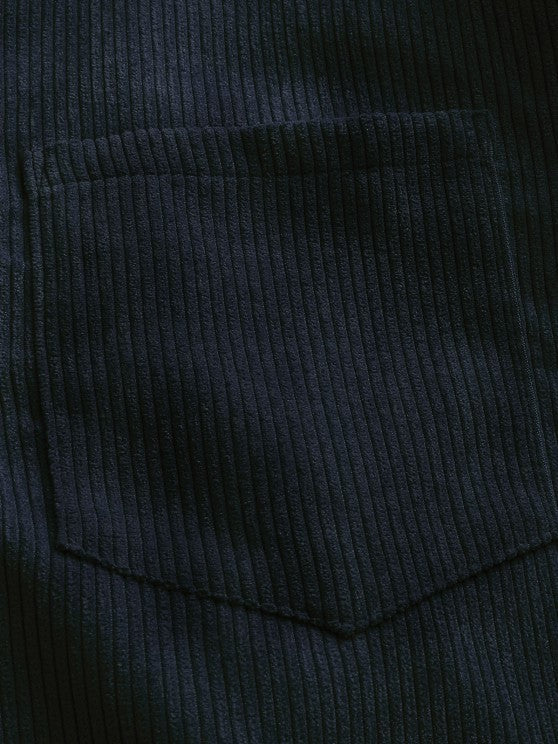 Close-up of navy corduroy chest pocket with stitched edge