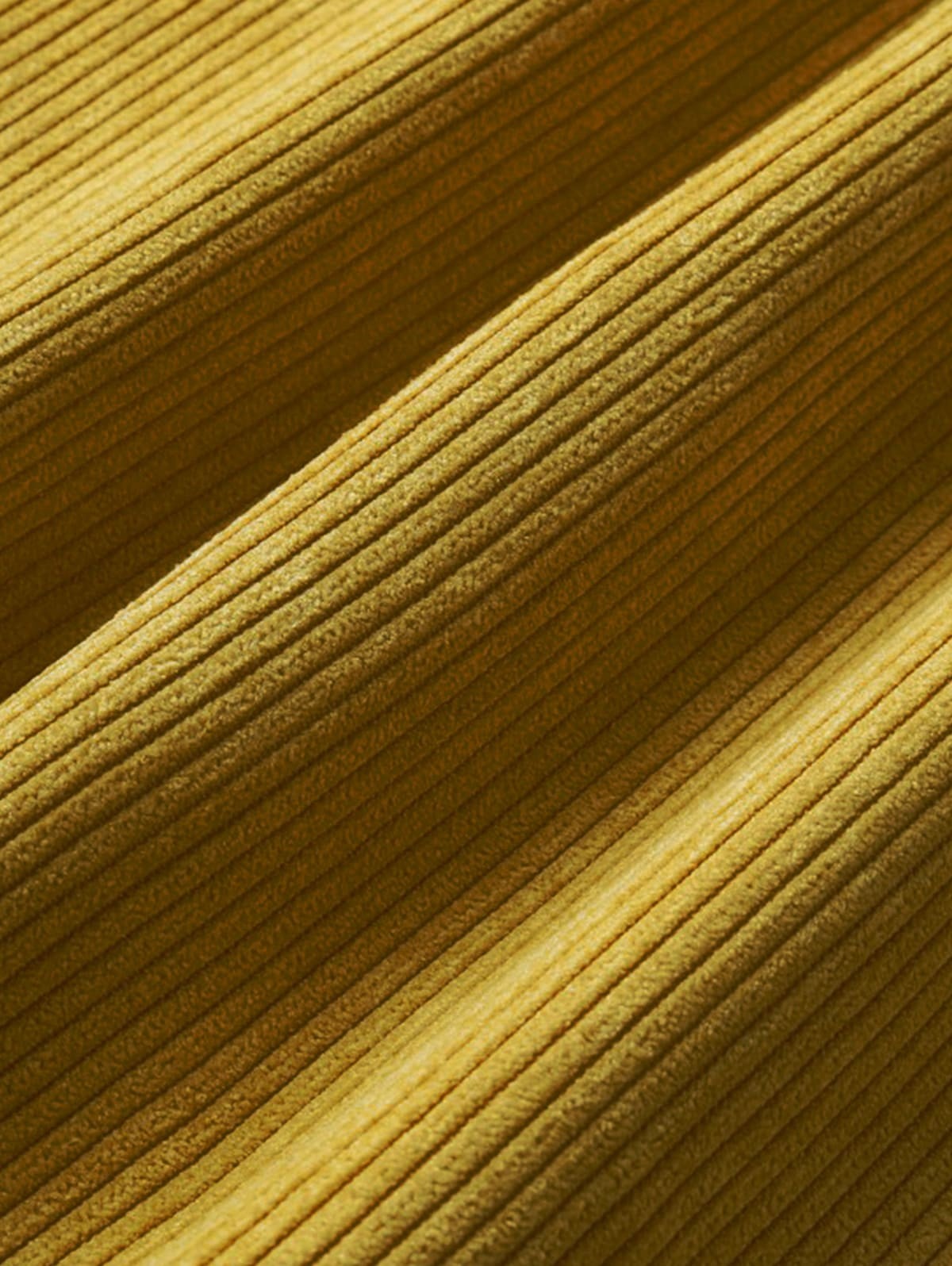 Close-up of mustard yellow corduroy fabric texture