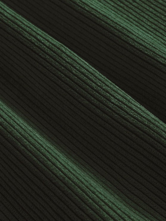 Close-up of forest green corduroy ribbed fabric texture