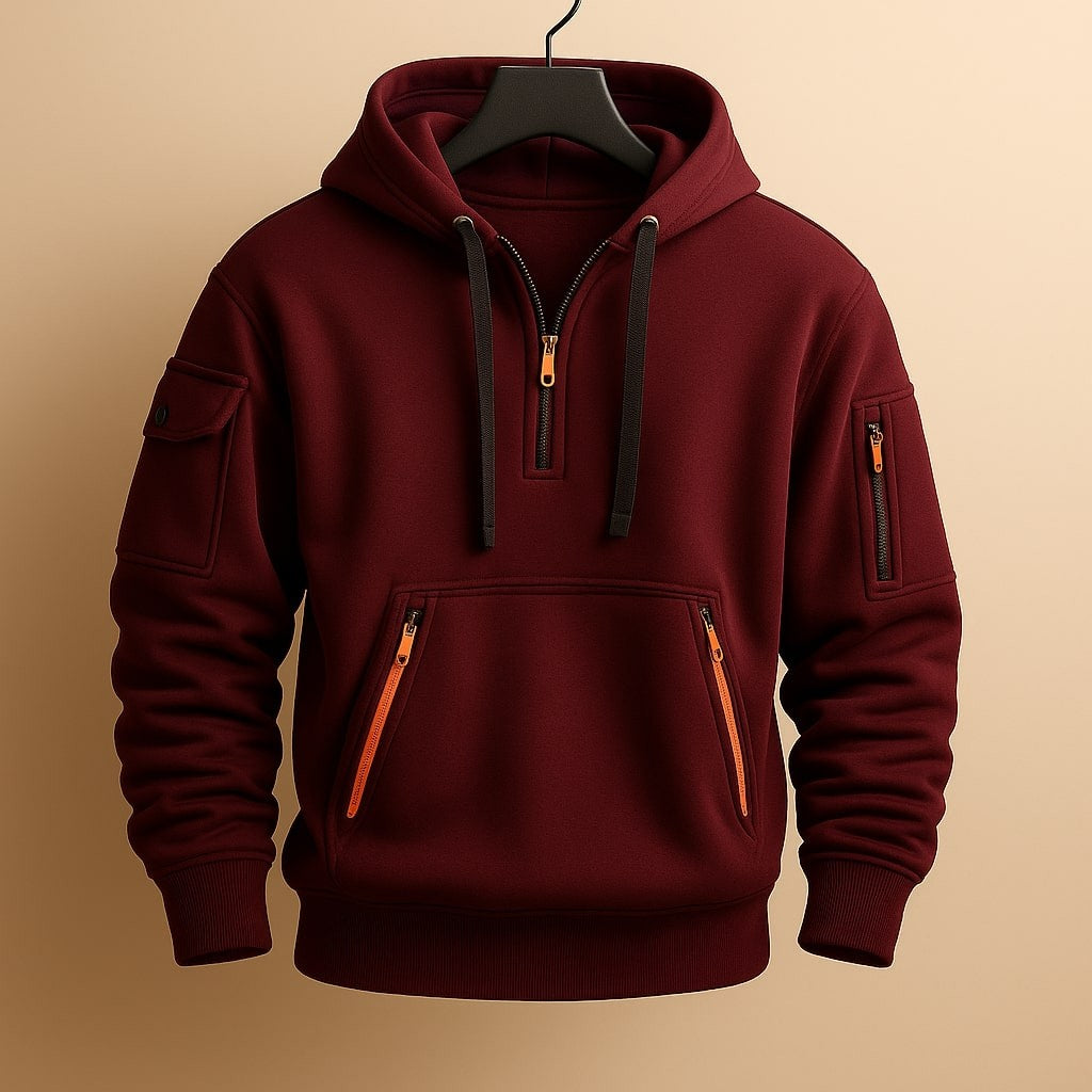 Burgundy fleece hoodie with half-zip neckline and orange zip pockets