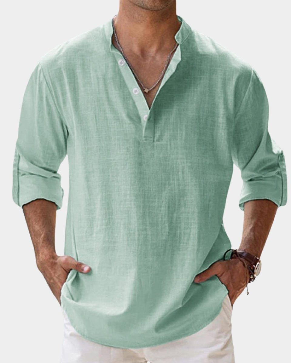 Mint green linen Henley shirt showing roll-up sleeves and V-neck